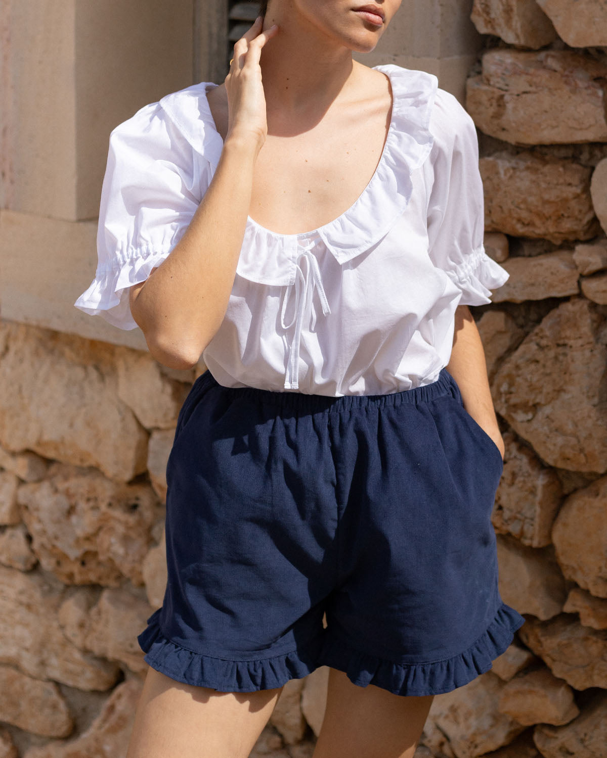 navy micro cord shorts with ruffle hem, pockets, elastic waistband