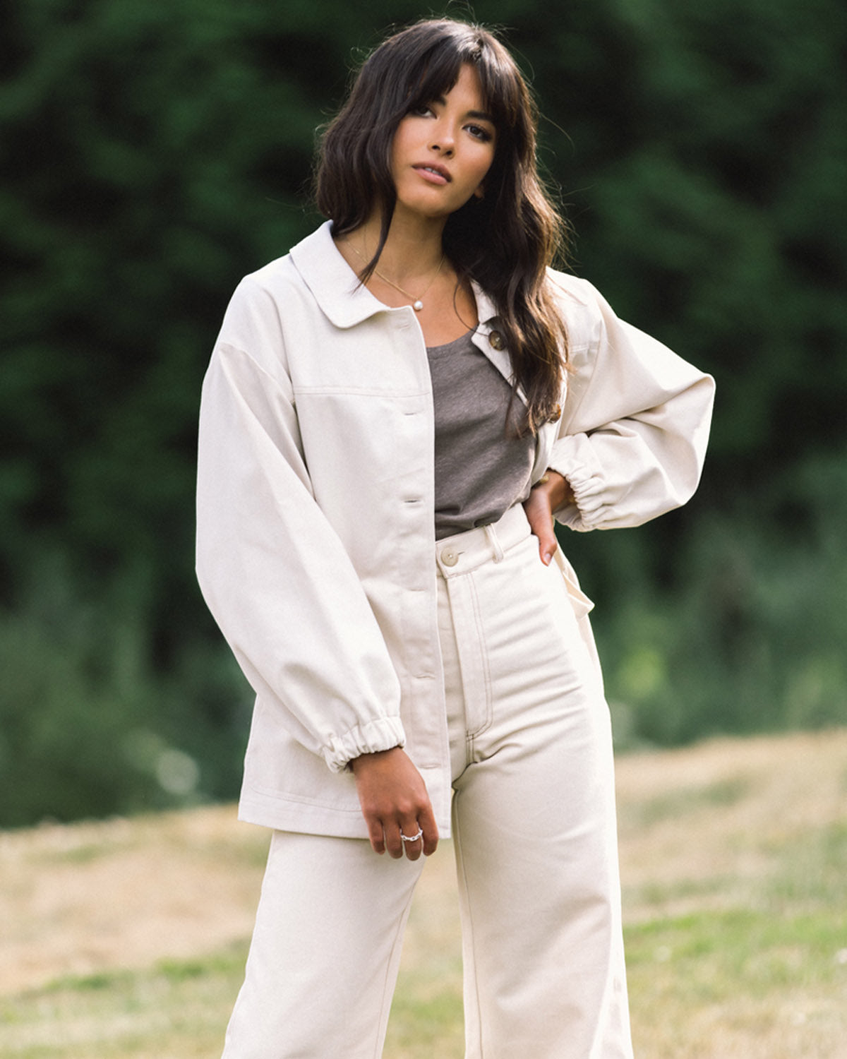 cream-coloured fall jacket with front pockets, cinch waist, and elastic sleeves