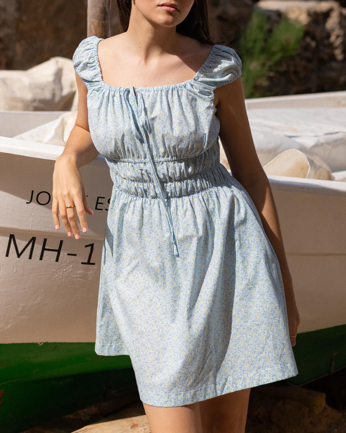 blue and yellow floral mini dress with cap sleeves and cinchable bust