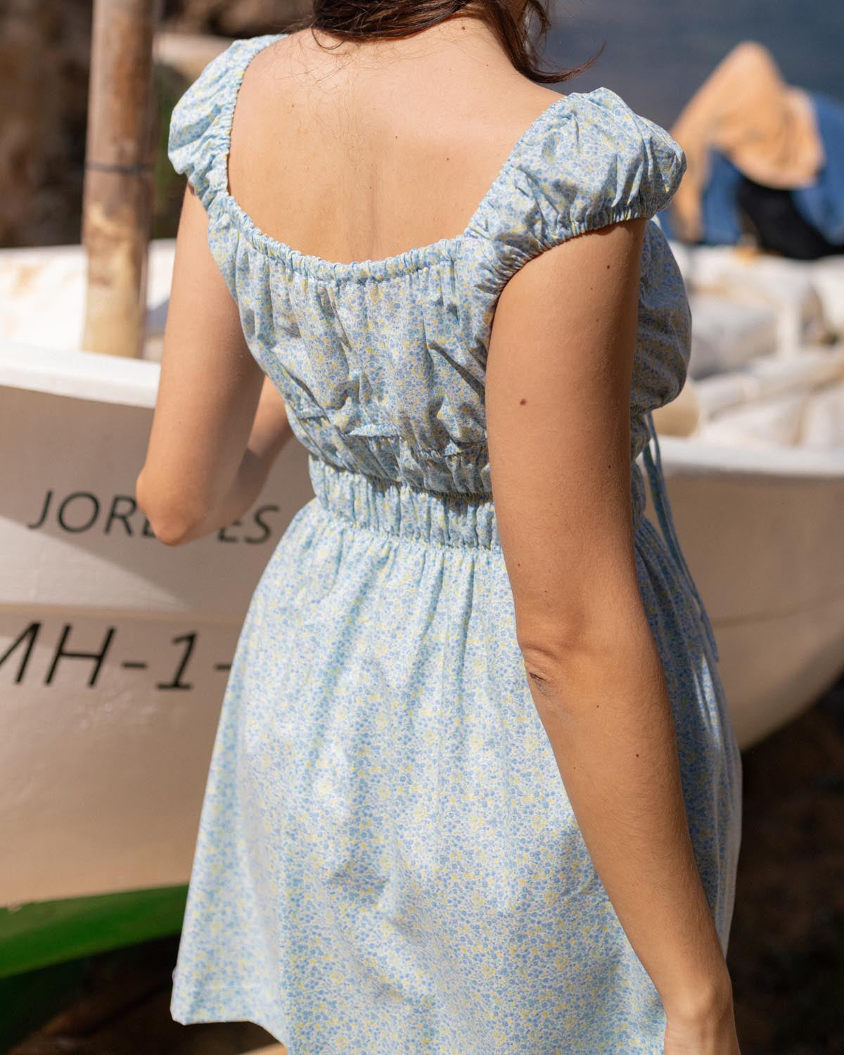 blue and yellow floral mini dress with cap sleeves and cinchable bust