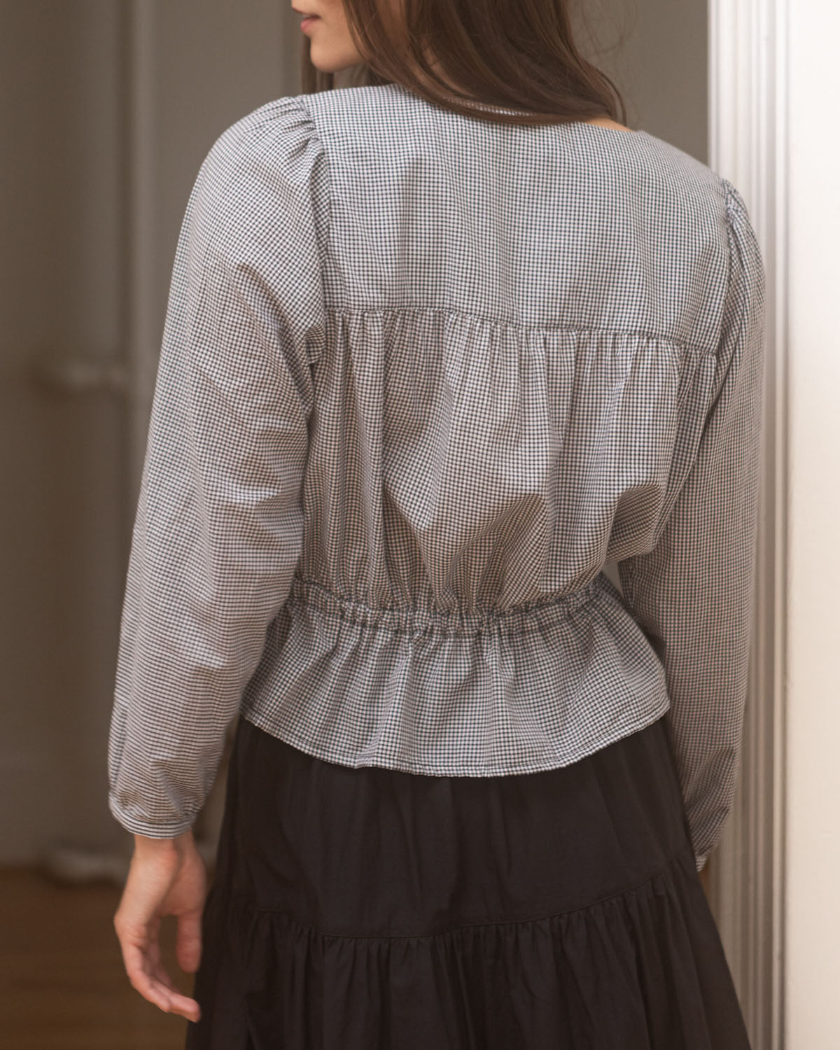 black and white gingham blouse with button front and elastic tie at waist