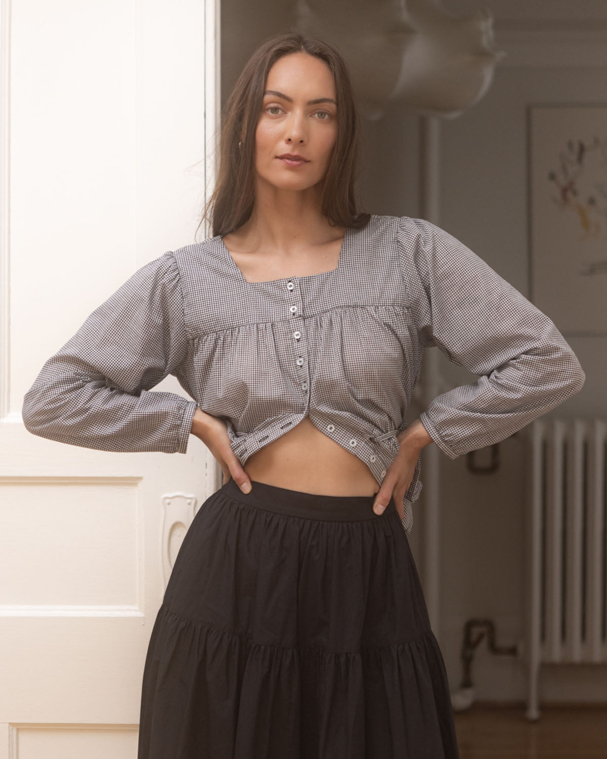 black and white gingham blouse with button front and elastic tie at waist