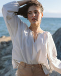 white and blue striped blouse with elastic sleeve cuffs and tie