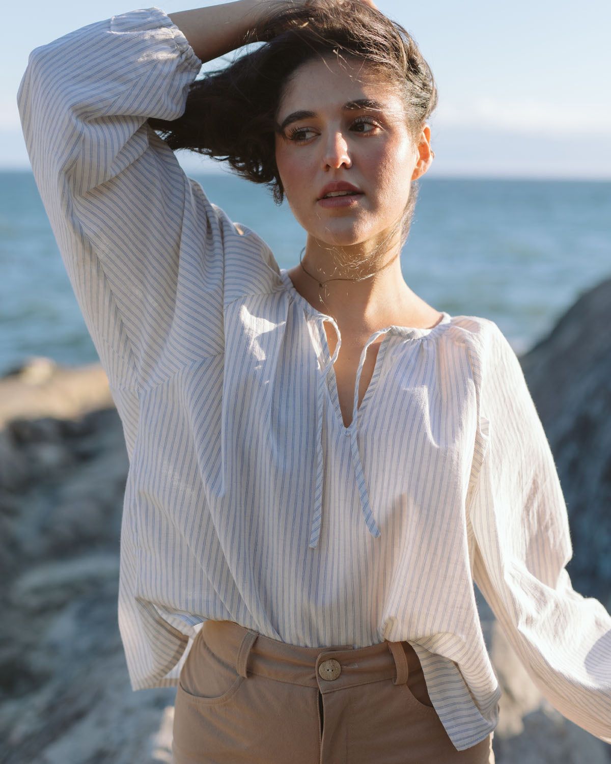 white and blue striped blouse with elastic sleeve cuffs and tie