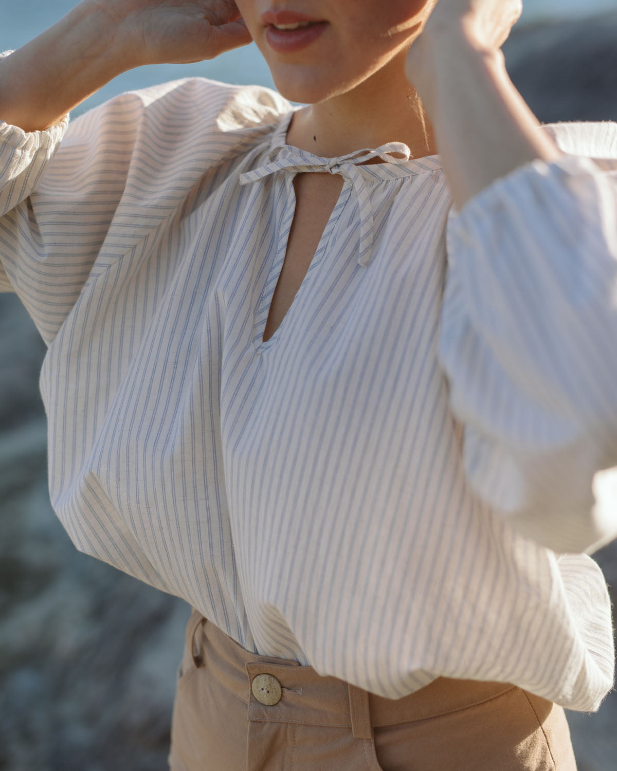 white and blue striped blouse with elastic sleeve cuffs and tie