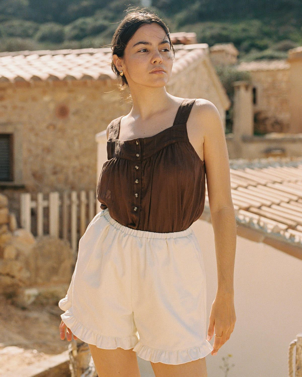 cream shorts with ruffle hem pockets, thin elastic waistband