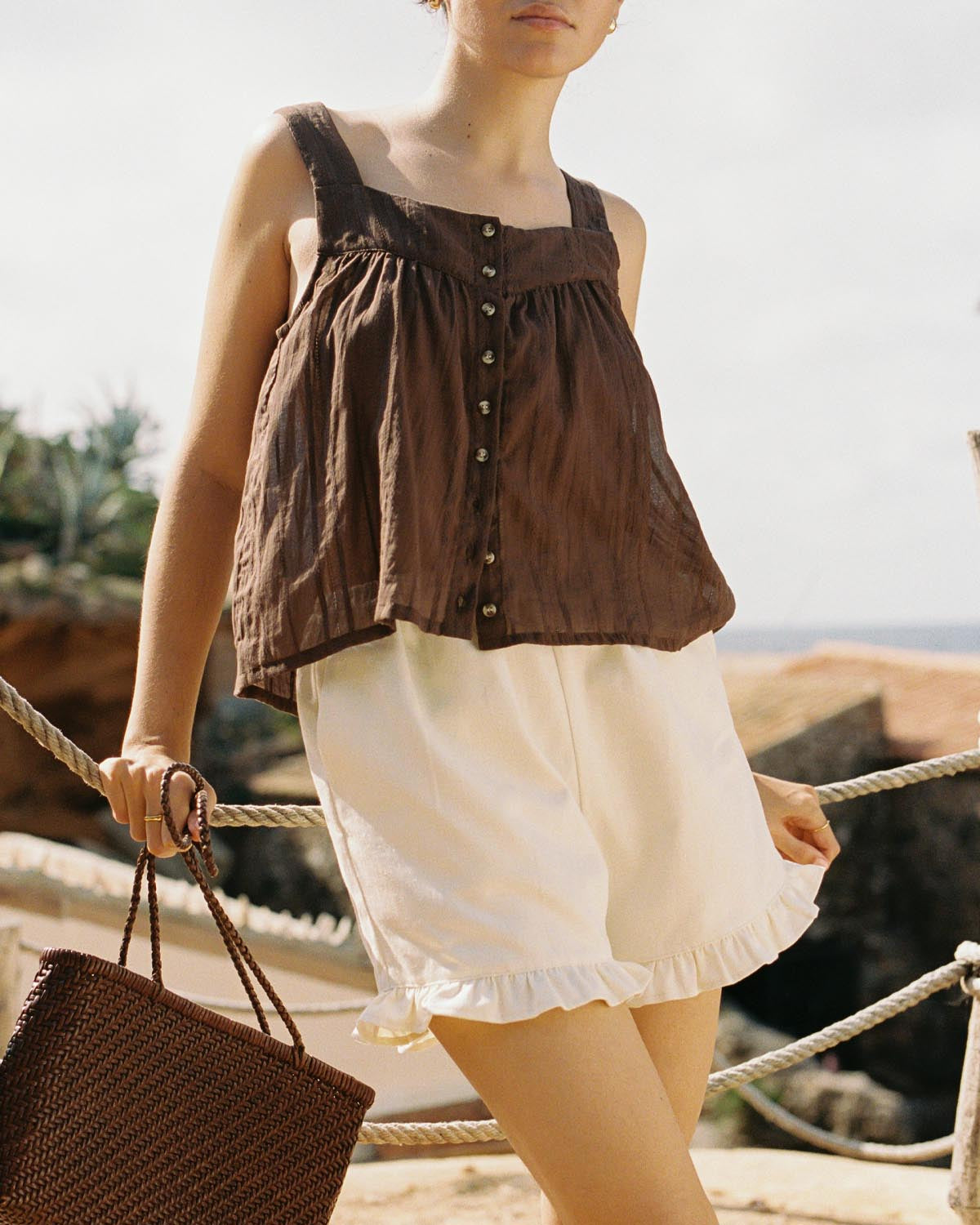 cream shorts with ruffle hem pockets, thin elastic waistband