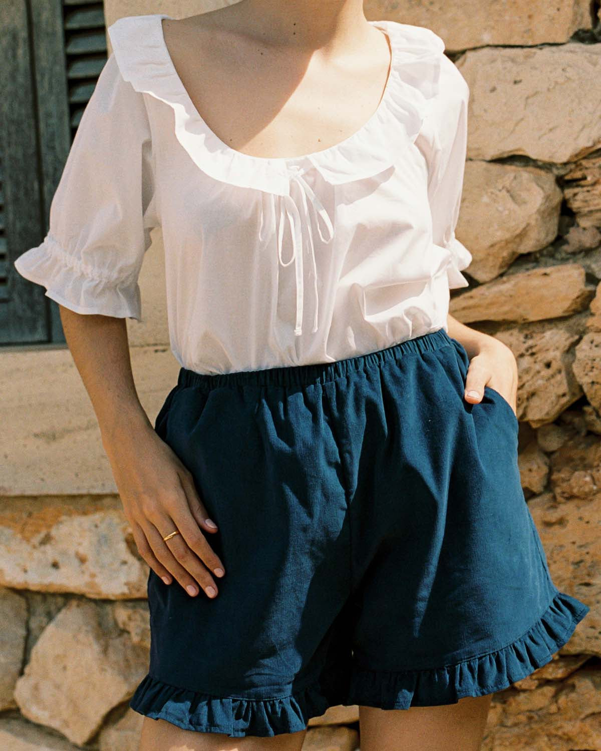 navy micro cord shorts with ruffle hem, pockets, elastic waistband