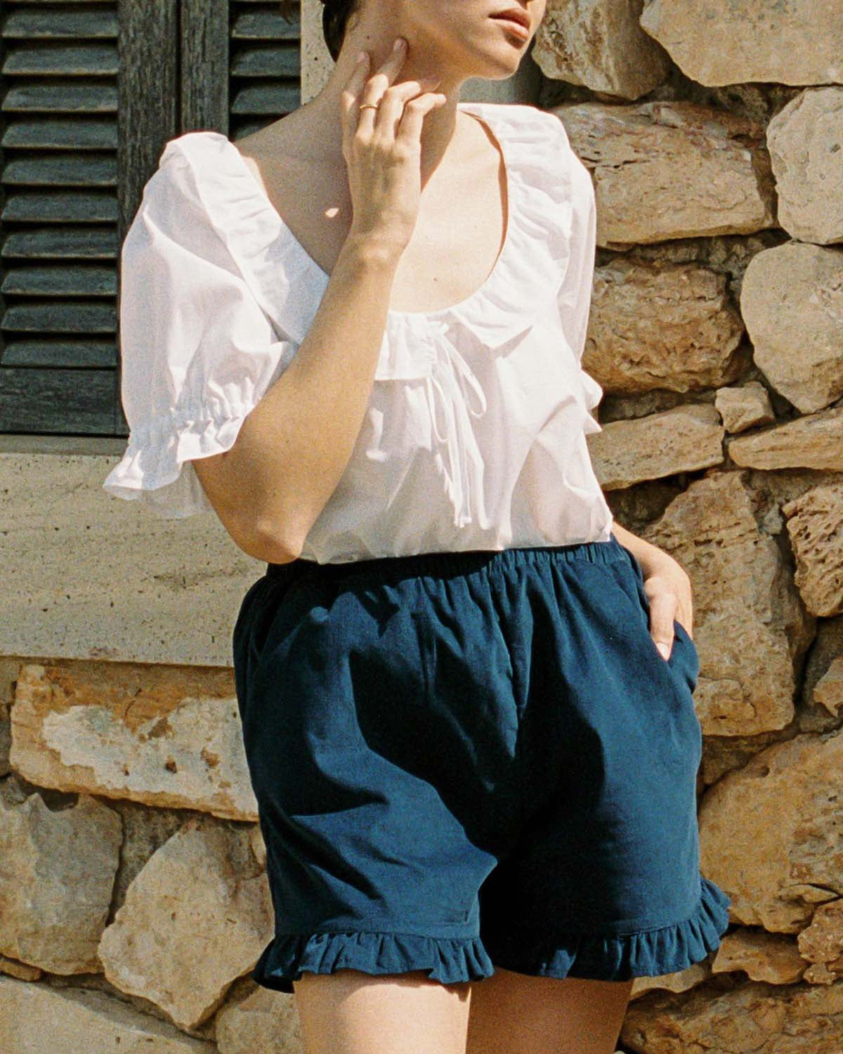 navy micro cord shorts with ruffle hem, pockets, elastic waistband