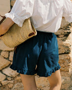 navy micro cord shorts with ruffle hem, pockets, elastic waistband