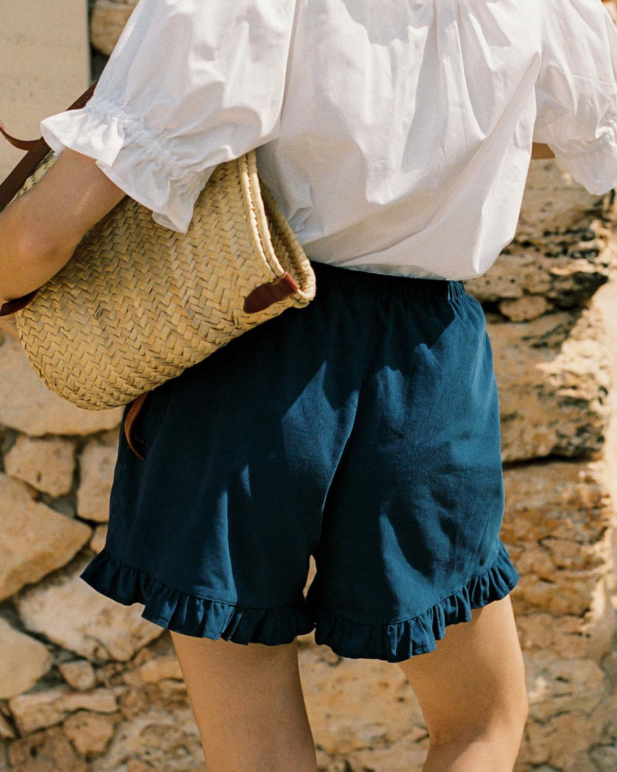 navy micro cord shorts with ruffle hem, pockets, elastic waistband