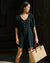 black linen romper with puff sleeves and button front