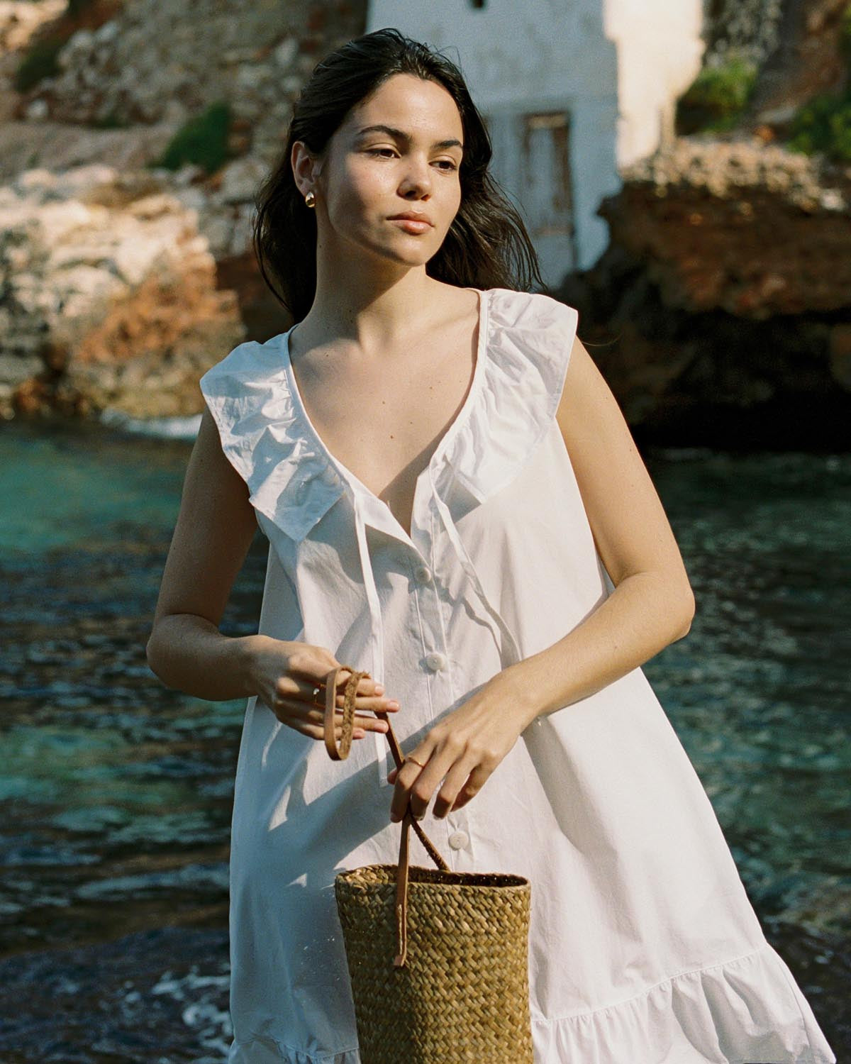 ivory cotton mini dress with ruffle hem, front ties, and button front