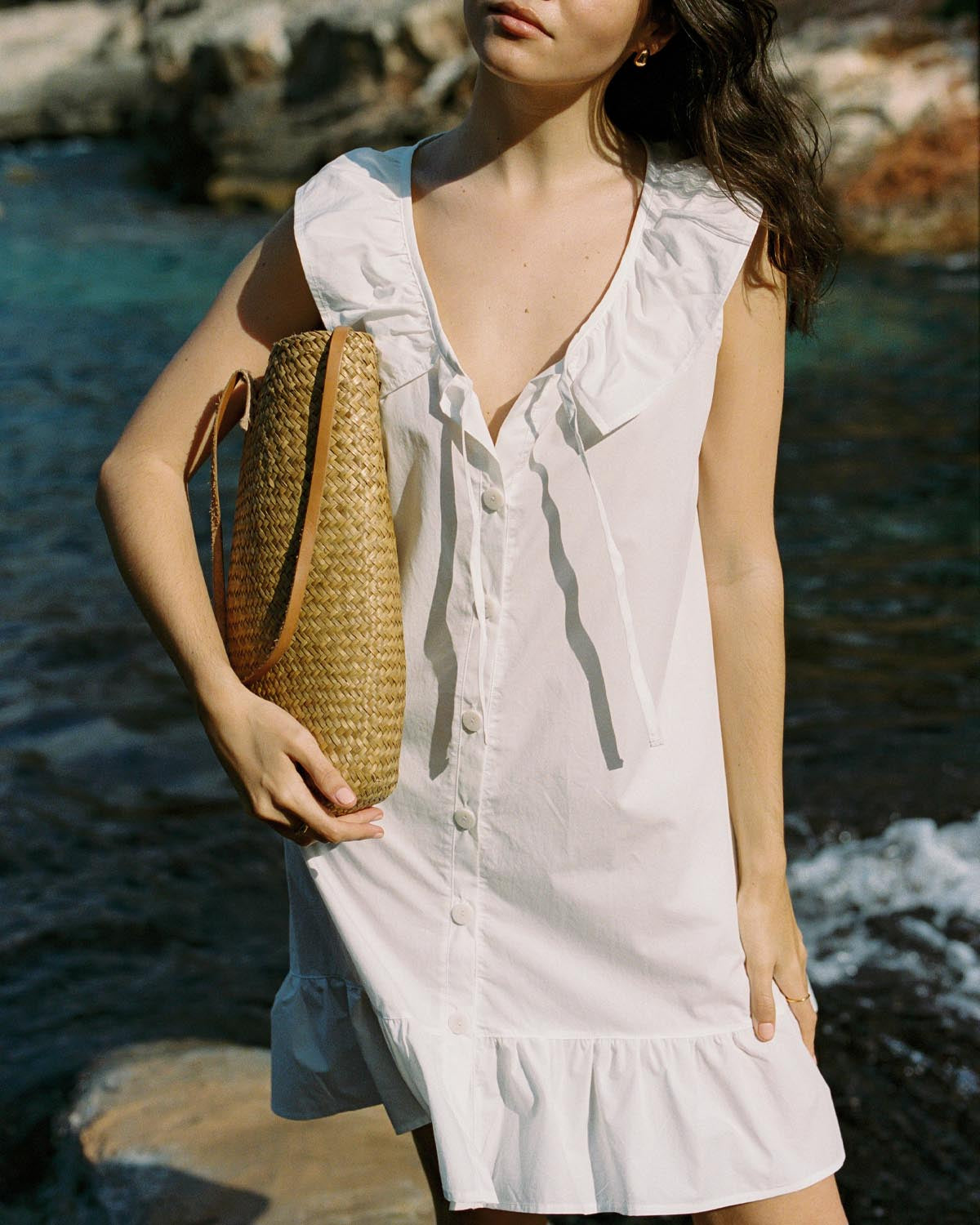 ivory cotton mini dress with ruffle hem, front ties, and button front