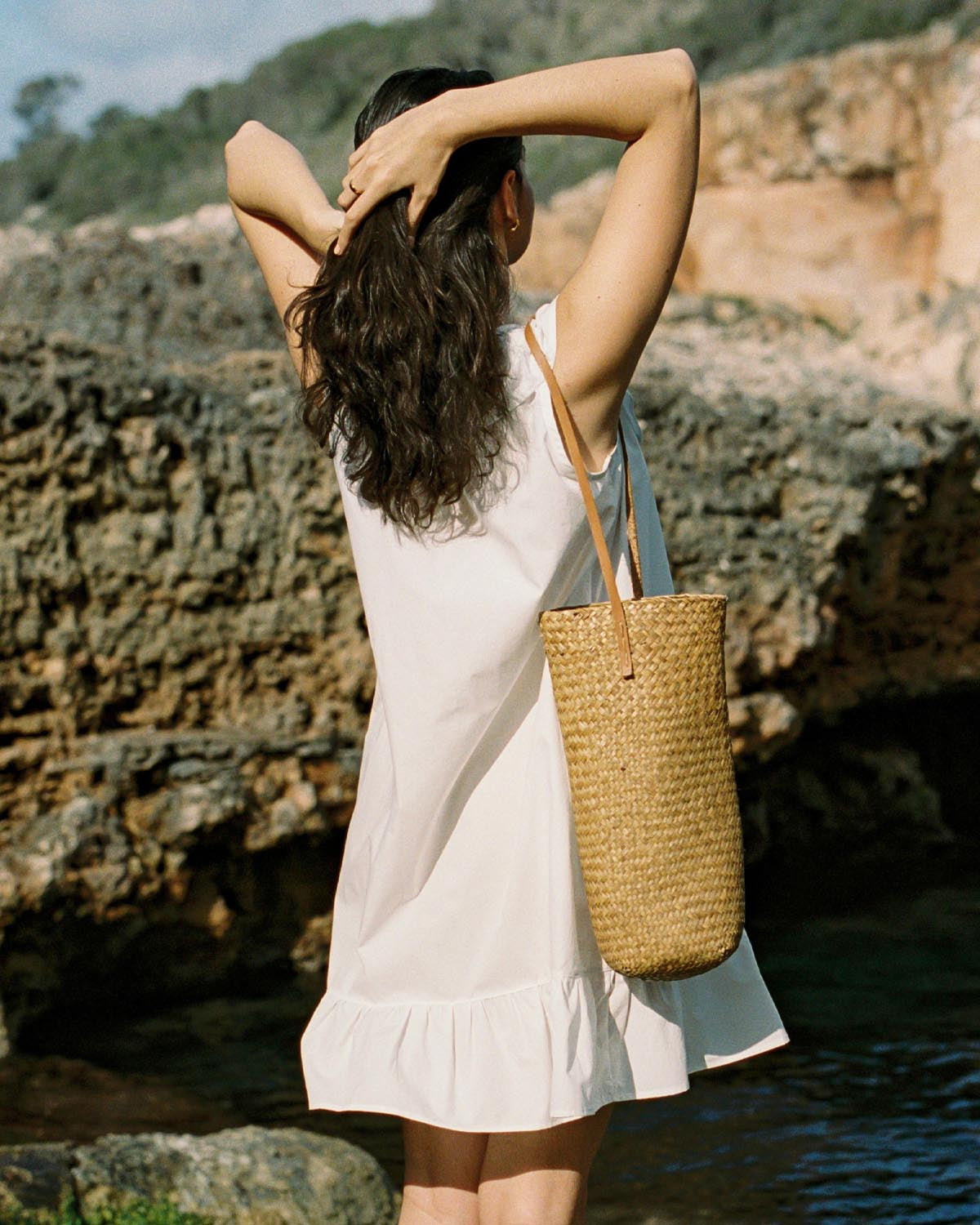 ivory cotton mini dress with ruffle hem, front ties, and button front