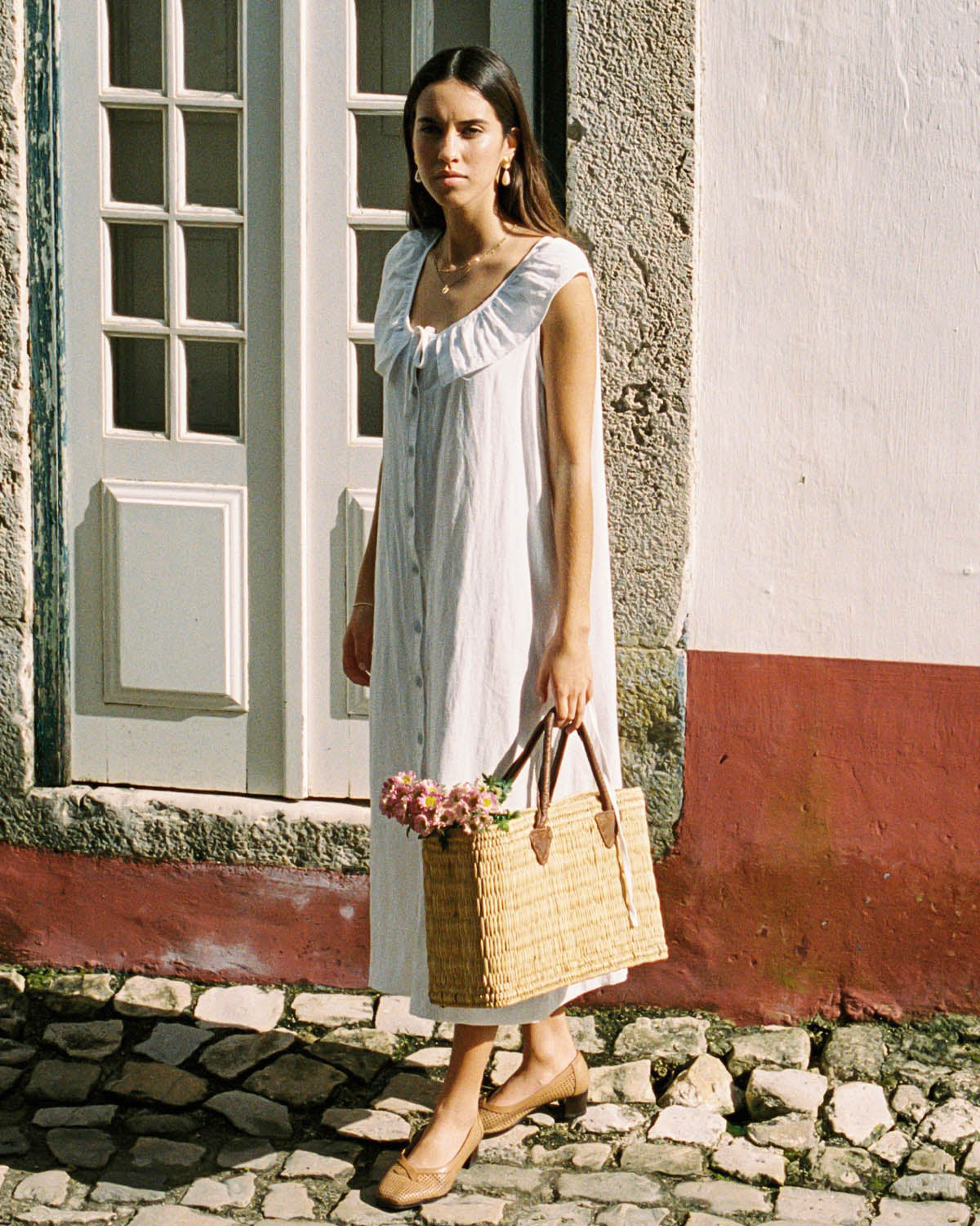 white sleeveless dress with button front and ties, made from 100% linen