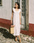 white sleeveless dress with button front and ties, made from 100% linen