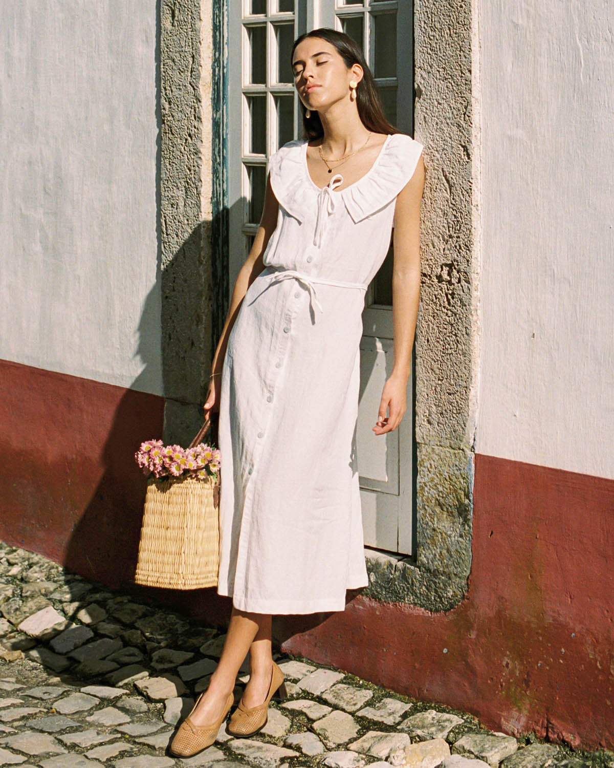 white sleeveless dress with button front and ties, made from 100% linen