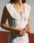 white sleeveless dress with button front and ties, made from 100% linen