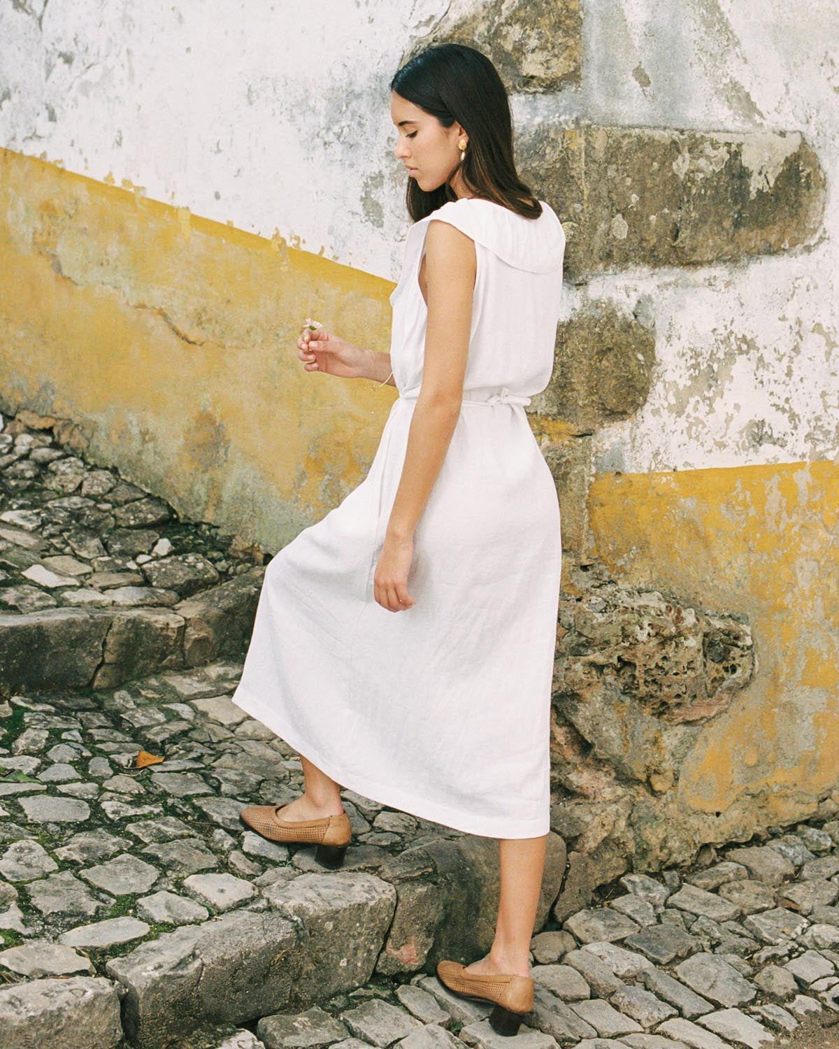 white sleeveless dress with button front and ties, made from 100% linen