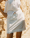 ivory mini skirt with tie front waistband and lace trim hem