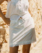 ivory mini skirt with tie front waistband and lace trim hem