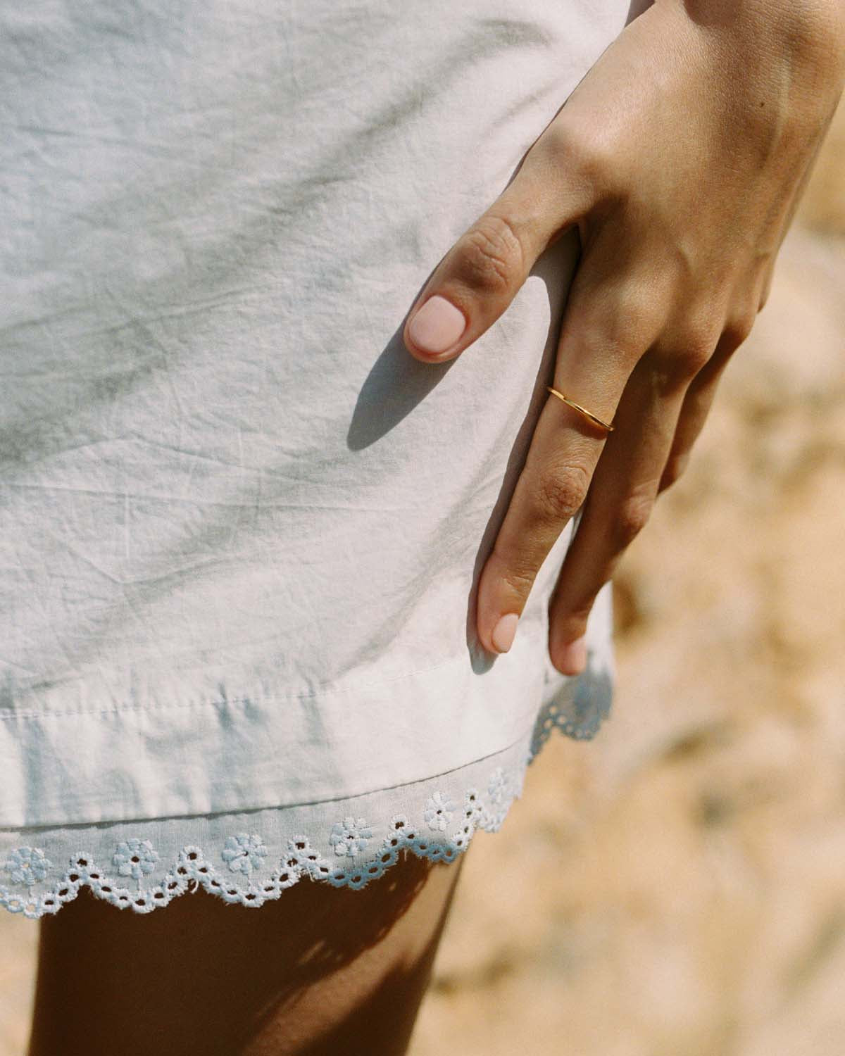 ivory mini skirt with tie front waistband and lace trim hem