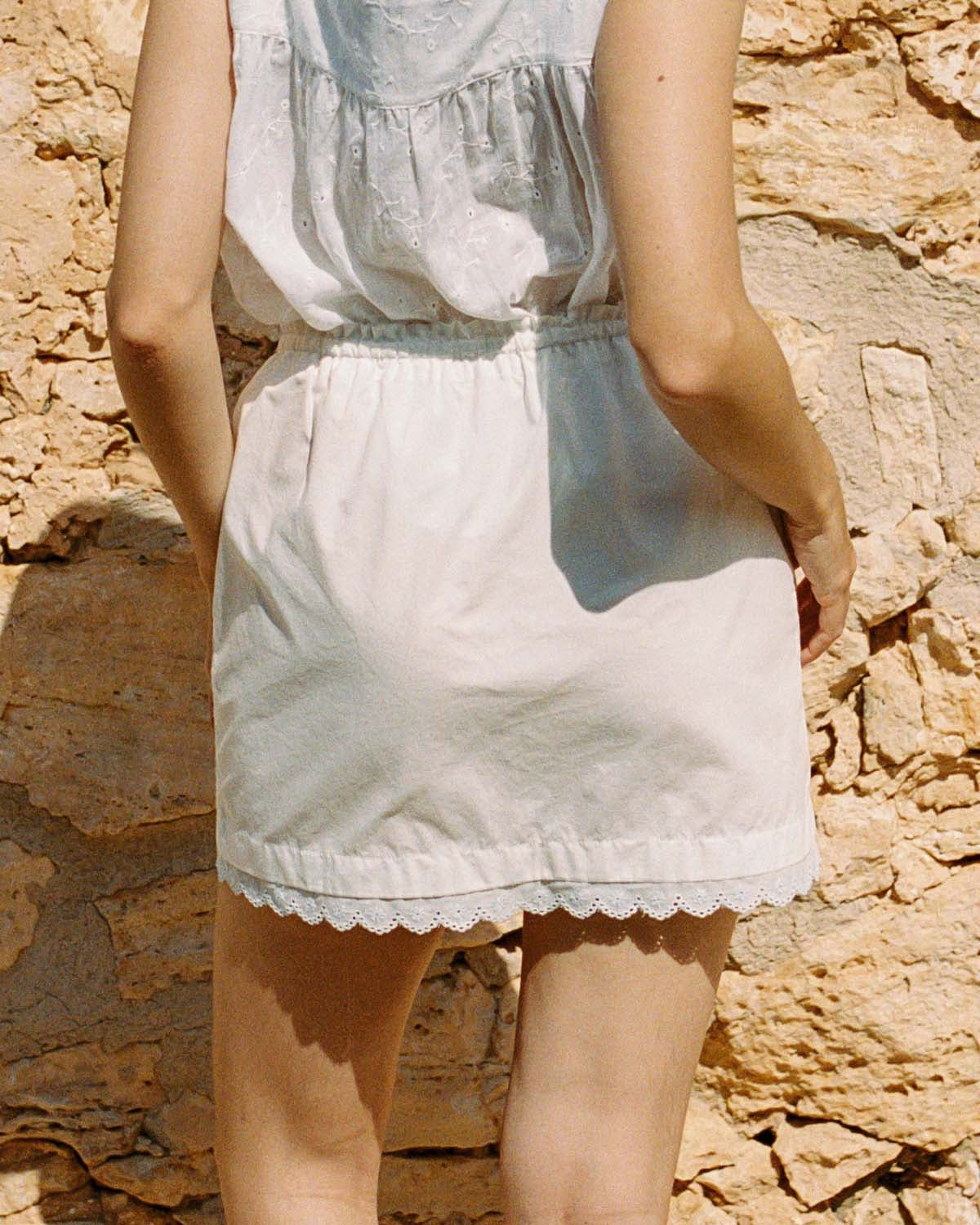 ivory mini skirt with tie front waistband and lace trim hem