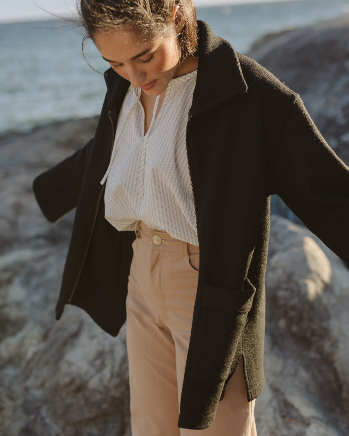 black wool coat with front zipper and pockets