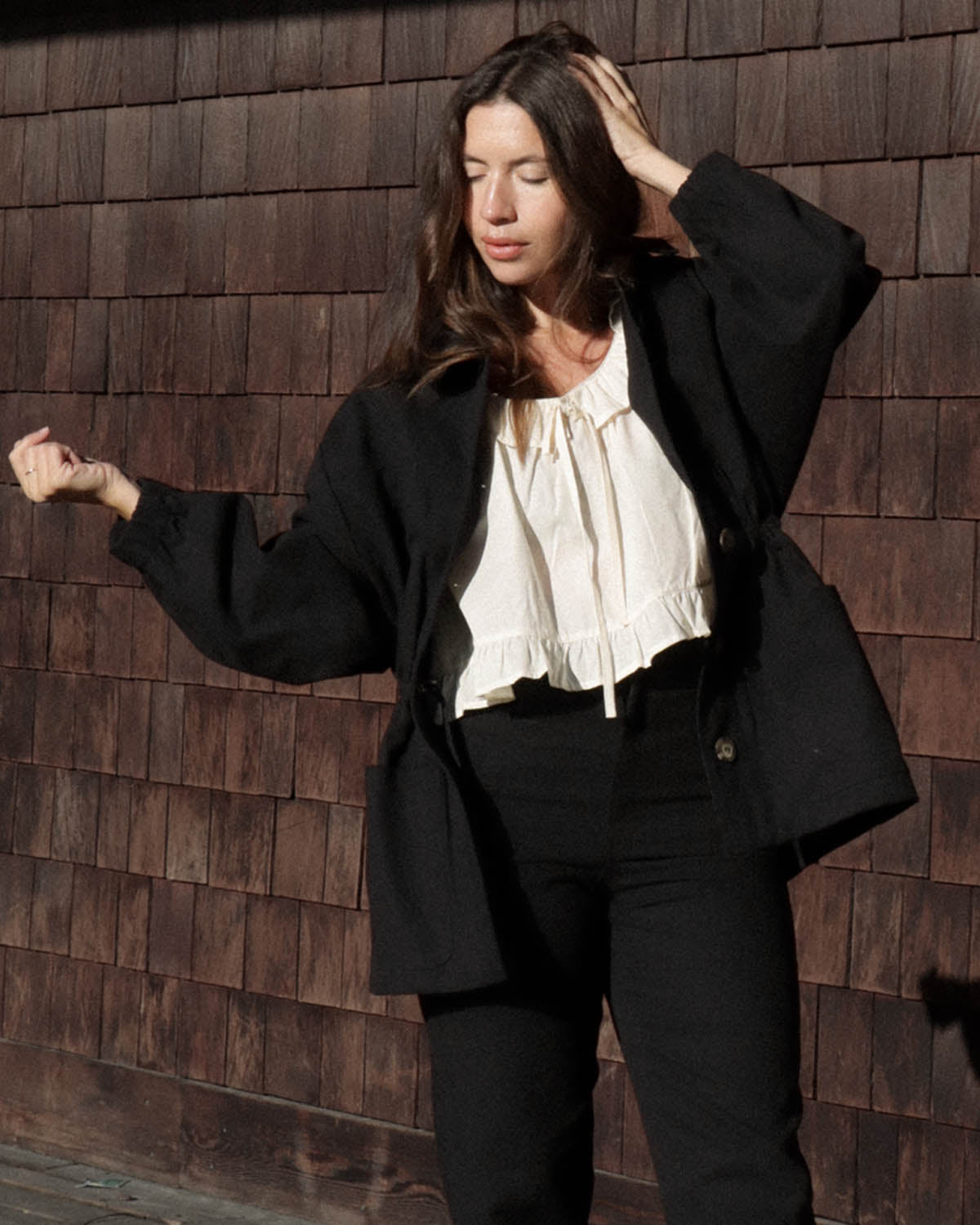 black button-front jacket with pockets and elastic sleeves, made from cotton