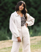 cream-coloured fall jacket with front pockets, cinch waist, and elastic sleeves