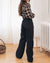 black high-waisted loose leg pants with raw hem