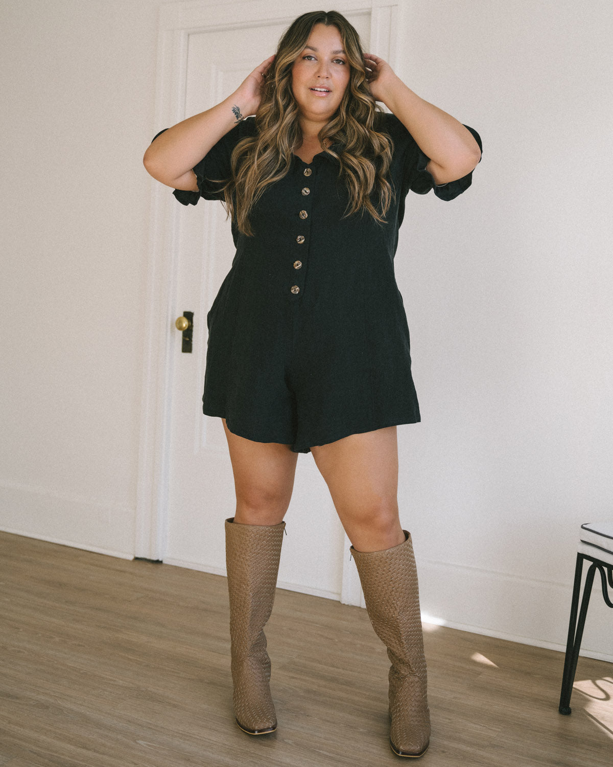 black linen romper with puff sleeves and button front