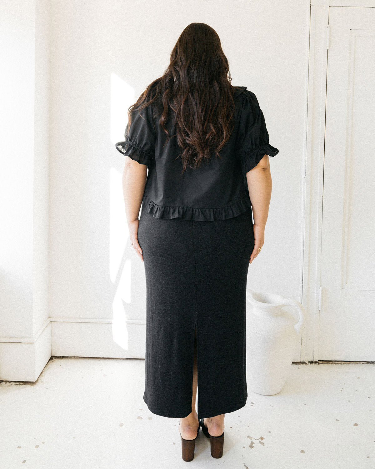 black knit stretchy skirt with elastic waistband and back slit